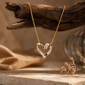 Interlocking Crystal Baguette Heart Pendant Necklace – Elegant Gold-Tone Rope Chain